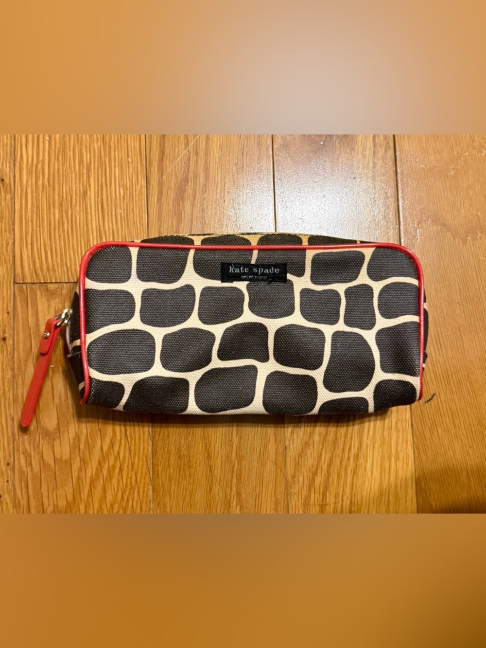 Kate Spade New York cosmetic bag or pencil case featuring a signature giraffe-